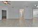Large living room with tile flooring and multiple doorways leading to other rooms at 329 Seneca Falls Dr, Apollo Beach, FL 33572
