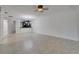 Spacious living room with modern tile flooring connected to kitchen bar area at 329 Seneca Falls Dr, Apollo Beach, FL 33572