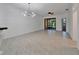 Spacious living room with tiled floor and modern light fixture. Entry to lanai at 329 Seneca Falls Dr, Apollo Beach, FL 33572