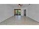 Bright living room with tile flooring and sliding glass doors to a screened lanai at 329 Seneca Falls Dr, Apollo Beach, FL 33572