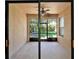 An enclosed patio with neutral paint has sliding glass doors looking out to the backyard at 329 Seneca Falls Dr, Apollo Beach, FL 33572