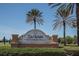 Del Webb Southshore Falls entrance sign with palm trees against a blue sky at 329 Seneca Falls Dr, Apollo Beach, FL 33572