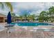 Community pool with lounge chairs and umbrellas offers relaxation and recreation at 329 Seneca Falls Dr, Apollo Beach, FL 33572