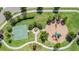 Aerial view of a playground and basketball court surrounded by landscaped gardens and green grass at 33228 Kateland Dr, Wesley Chapel, FL 33545