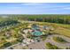 Overhead aerial view of neighborhood park, community pool, splashpad, and play area perfect for outdoor recreation at 33228 Kateland Dr, Wesley Chapel, FL 33545