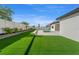 Lush backyard featuring a pristine lawn, manicured landscaping, and a refreshing swimming pool at 33228 Kateland Dr, Wesley Chapel, FL 33545