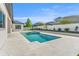 Beautiful backyard pool with integrated spa, surrounded by travertine pavers and landscaping at 33228 Kateland Dr, Wesley Chapel, FL 33545