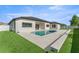 A stunning backyard with a modern pool and lush landscaping creates a serene outdoor retreat at 33228 Kateland Dr, Wesley Chapel, FL 33545