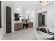 Luxurious bathroom with double vanities, a freestanding tub, and a stylish chandelier at 33228 Kateland Dr, Wesley Chapel, FL 33545