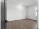 This simple, empty bedroom features a dark interior door and light, minimalist colors at 33228 Kateland Dr, Wesley Chapel, FL 33545