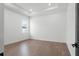 A simple, empty bedroom with light wood flooring and an abundance of natural light at 33228 Kateland Dr, Wesley Chapel, FL 33545