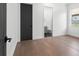 A bright bedroom with dark interior doors and light wood flooring provides an open and airy space at 33228 Kateland Dr, Wesley Chapel, FL 33545