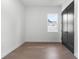 Neutral bedroom featuring wood floors, fresh paint, white trim, and a single window at 33228 Kateland Dr, Wesley Chapel, FL 33545