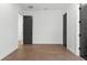An airy bedroom features wood flooring and neutral walls at 33228 Kateland Dr, Wesley Chapel, FL 33545