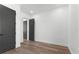 A bright bedroom offers dark doors, neutral paint, and modern fixtures at 33228 Kateland Dr, Wesley Chapel, FL 33545