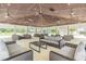 Spacious outdoor lounge area with ample seating and ceiling fans for comfort at 33228 Kateland Dr, Wesley Chapel, FL 33545
