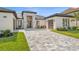 Stunning home boasts a modern architectural style, manicured landscaping, and a spacious driveway at 33228 Kateland Dr, Wesley Chapel, FL 33545