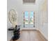 Bright foyer featuring high ceiling, elegant decor, and view of the outdoors at 33228 Kateland Dr, Wesley Chapel, FL 33545