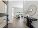 Bright foyer with a modern accent table and views into the living room and pool at 33228 Kateland Dr, Wesley Chapel, FL 33545