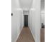 Hallway with wood floors and view of bedroom and bathroom at 33228 Kateland Dr, Wesley Chapel, FL 33545