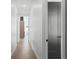 Clean, modern hallway leading to various rooms, offering a bright and airy feel at 33228 Kateland Dr, Wesley Chapel, FL 33545