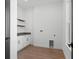 Laundry room with new cabinets, wood floors, new paint and a gray countertop at 33228 Kateland Dr, Wesley Chapel, FL 33545