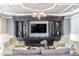 Living room features a fireplace, seating area, and a large built-in shelving unit with decorative objects at 33228 Kateland Dr, Wesley Chapel, FL 33545