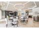 A living room features coffered ceilings, a wall unit, and an adjacent kitchen area at 33228 Kateland Dr, Wesley Chapel, FL 33545
