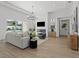 Open living room with a fireplace, modern chandelier, and stylish decor at 33228 Kateland Dr, Wesley Chapel, FL 33545