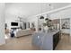 Spacious, open-concept living space with a stylish kitchen island, modern appliances, and hardwood flooring at 33228 Kateland Dr, Wesley Chapel, FL 33545