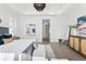 Staged main bedroom with a tray ceiling, accent furniture and modern decor and lots of natural light at 33228 Kateland Dr, Wesley Chapel, FL 33545