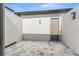 Enclosed paved patio space offering privacy and potential for outdoor relaxation at 33228 Kateland Dr, Wesley Chapel, FL 33545