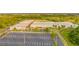 Aerial shot of school complex with parking, athletic fields, and landscaped areas, community focal point at 33228 Kateland Dr, Wesley Chapel, FL 33545