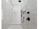 Walk-in shower featuring white marble style tile and black fixtures at 33228 Kateland Dr, Wesley Chapel, FL 33545