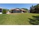 Expansive backyard featuring a screened porch and lush green lawn at 3330 Foxridge Cir, Tampa, FL 33618