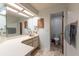 Well-lit bathroom featuring a large mirror, spacious vanity, and toilet room at 3330 Foxridge Cir, Tampa, FL 33618