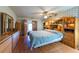 Spacious bedroom featuring wood floors, built-in shelving, and a ceiling fan at 3330 Foxridge Cir, Tampa, FL 33618