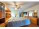 Comfortable bedroom features a ceiling fan, built-in storage, and wood furnishings at 3330 Foxridge Cir, Tampa, FL 33618