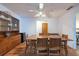 Open dining room with wood floors, vintage built-in cabinet and modern ceiling fan at 3330 Foxridge Cir, Tampa, FL 33618