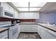Well-lit kitchen with white appliances, white cabinets, and red backsplash at 3330 Foxridge Cir, Tampa, FL 33618