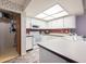 Well-lit kitchen features white cabinets, red tile backsplash, and a breakfast bar at 3330 Foxridge Cir, Tampa, FL 33618