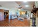 Open living room features a stone fireplace, wood laminate flooring, and comfortable seating at 3330 Foxridge Cir, Tampa, FL 33618