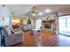 Cozy living room with a stone fireplace, comfortable seating, and wood laminate flooring at 3330 Foxridge Cir, Tampa, FL 33618