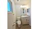 Bathroom featuring a toilet, vanity with marble top, and decorative mirror at 4505 Alligator Dr, New Port Richey, FL 34653
