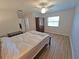 Spacious bedroom with wood floors, a ceiling fan, and a view of the closet at 4505 Alligator Dr, New Port Richey, FL 34653