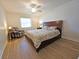 Bedroom with wood floors, a ceiling fan, and a bed with decorative pillows at 4505 Alligator Dr, New Port Richey, FL 34653