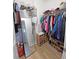 Walk-in closet with hanging clothes, shelves, and a mirror at 4505 Alligator Dr, New Port Richey, FL 34653