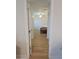 Hallway view leading into the bedroom with wood flooring and neutral paint at 4505 Alligator Dr, New Port Richey, FL 34653