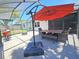 Patio with outdoor dining area and shade umbrella, perfect for enjoying the outdoors at 4505 Alligator Dr, New Port Richey, FL 34653