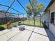 Enjoy the outdoors in this screened patio with outdoor furniture, grill, fire pit, and a fenced backyard at 4505 Alligator Dr, New Port Richey, FL 34653